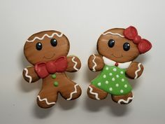 two decorated gingerbread cookies sitting side by side