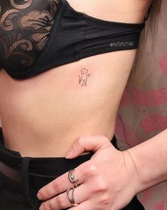 a woman with a small tattoo on her stomach