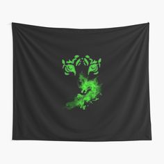 a green and black wall hanging tapestry with an image of a demon face on it