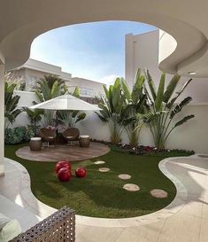 an open courtyard with grass and rocks on the ground