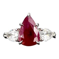 This stunning ring features a GIA certified natural ruby and GIA certified diamond ring set in platinum. The natural ruby weighs 3.02 ct and the pear shaped diamonds weigh 1.00 ct. The natural ruby is heat treated, and the pear shaped diamonds are D/E in color and VS1 in clarity. This is such a stunning piece to add to anyone's collection. Red Ruby Ring With Brilliant Pear-shaped Cut, Red Pear-shaped Ruby Ring With Brilliant Cut, Red Pear-shaped Ruby Ring, Diamond Ring Set, Diamond Ring Settings, Pear Shaped Diamond, Natural Ruby, Gia Certified Diamonds, Cocktail Rings