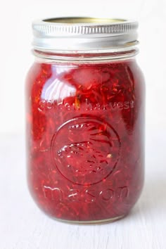 a jar filled with red liquid sitting on top of a table