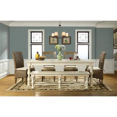 a dining room with blue walls and white furniture