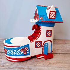 a paper model of a house on top of a wooden table