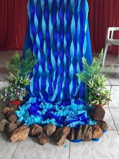 a blue cloth draped over some rocks and plants