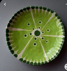 a green and white plate sitting on top of a table