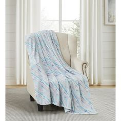 a white chair with a blue blanket on it