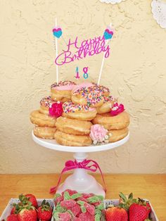 a birthday cake with donuts and strawberries