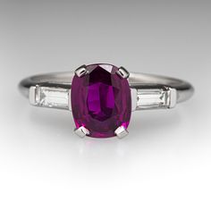 This captivating ring is centered with one (1) unheated cushion cut natural ruby set into a four-prong setting. The shoulders of the ring are each accented with one (1) channel set baguette cut diamond. The ring measures 8.6mm at the top, rises 7.0mm above the finger, and tapers to 2.0mm wide by 1.8mm thick at the base of the shank. It is crafted in platinum and is currently a size 8. Classic Gia Certified Cushion Cut Ruby Ring, Classic Gia Certified Cushion-cut Ruby Ring, Classic Baguette-cut Ruby Ring, Classic Square Cut Ruby Ring, Ruby Set, Baguette Diamonds, Baguette Cut Diamond, Channel Set, Baguette Cut