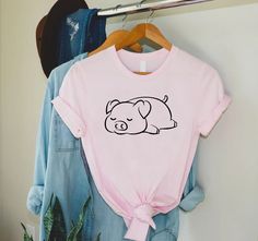 "Cute Pig Shirt, Pig Lover Gift, Sleepy Pig Shirt, Farm Girl Gift, Pig Farmer Shirt, Pig Owner Gift, Animal Lover Gift,Cute Farm Shirts Women 🎈HOW TO ORDER 1-) Please, check and review all the photos. 2-) Choose your t-shirt size and color. *Different styles of shirts may have different shades of same color choice due to different manufacturer brands. *For this reason, we recommend you to match shirts from the same styles if you want precisely matching colors (ex. Unisex, V-necks, Toddler, etc.). 3-) Click add to cart. You can go back to add more shirts. 4-)Click \"Proceed to check out\". 5-)When you check out, you can add a note to seller for any request. 🎈PRODUCT DESCRIPTION UNISEX SHIRTS * Unisex t shirt fits like a well-loved favorite, featuring a crew neck, short sleeves and designe Farm Shirts, Pig Shirt, Artistic Ideas, Pig Shirts, Farmer Shirt, Cute Pig, Pig Lovers, Cute Pigs, Matching Colors