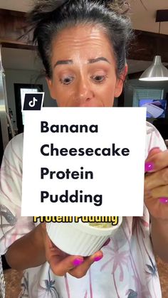 a woman holding up a sign with the words banana cheesecake protein pudding on it