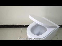 a white toilet with its lid open in a bathroom stall or restroom flooring area