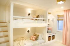 there are two bunk beds with pillows on the bottom and one is in the middle