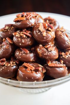 chocolate covered donuts with nuts and pecans in a bowl