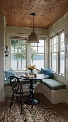 a table with two chairs and a window seat