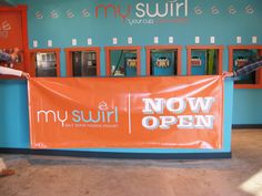 a man standing in front of a sign that says mysurir now open