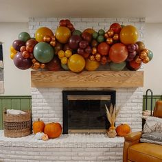 a living room filled with lots of balloons on top of a fire place and furniture