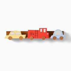 a wooden toy train with cars on it