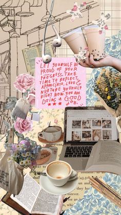 a laptop computer sitting on top of a table covered in books and flowers next to a cup of coffee