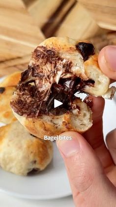 a person holding a half eaten pastry on a plate