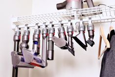 several different types of hair dryers hanging on a rack