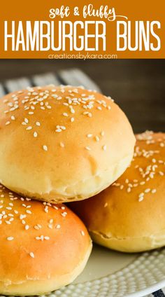 three hamburger buns stacked on top of each other with sesame seed sprinkles