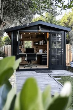 Outdoor office shed with modern decor, black desk, and ergonomic chair. Modern Shed Ideas, Garden Shed Colours, Office Shed Ideas, Outdoor Office Shed, Backyard Office Shed, Black Shed, Office Shed, Shed Office