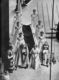 an old black and white photo of people dressed in costumes