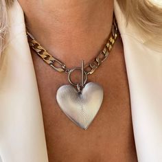 "This oversized heart pendant hangs from a statement figaro link chain with a toggle clasp closure! This chunky necklace is a must-have whether you plan to layer or style it solo.  Details * Stainless steel chain 11.5mm mixed gold and silver links. Water Resistant, Tarnish Free, Hypoallergenic * Chain Style: Figaro * Chain thickness: 2.5mm   * Different Chain lengths, from 16\" to 22\" inches long including the toggle closure. Choose the length from the dropdown menu. * Silver-plated brass heart Chunky Silver Necklace, Chain Necklace Silver, Figaro Necklace, Figaro Chain Necklace, Toggle Necklace, Large Heart, Figaro Chains, Necklace Heart, Figaro Chain