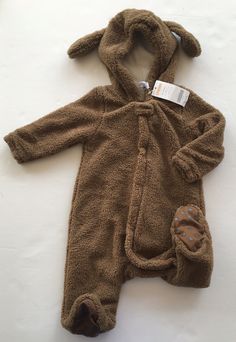 Here is a soft and fuzzy puppy one-piece from the Gymboree 2007 Dog Days line.  New with tags.  Size 12-18 months. It would be great as a Halloween costume or just to keep warm in winter weather. Dog Days Doggie One-Piece - 100% polyester plush romper has micro-fleece lining, floppy ears on the hood, zipper down the front with a snap closure at the neck, and rubberized paw-print treads on the fabric soles of the feet.  Color: Otter International Buyers - Please Note: Import duties, taxes and cha Brown Winter Onesie For Playtime, Cozy Fall Onesie For Playtime, Brown Onesie For Playtime In Fall, Brown Fall Onesie For Playtime, Fall Playtime Brown Onesie, Floppy Ears, Winter Weather, Baby & Toddler Clothing, Dog Days