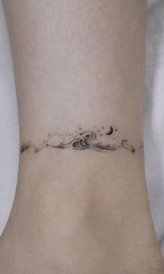 a small wave tattoo on the ankle