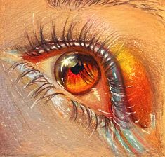 an eye is shown with colored pencils on the bottom and bottom part of it