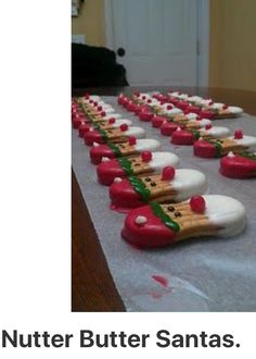 there is a table that has some kind of food on it and the caption says nutter butter santas