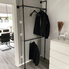 a coat rack with clothes hanging on it