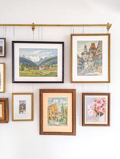 many framed pictures hang on the wall