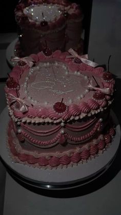 three tiered cake with pink icing and decorations