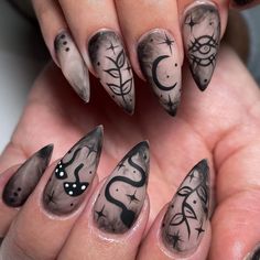 a woman's nails with black and white designs on them