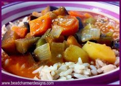 a purple and white bowl filled with rice and vegetables