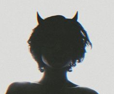 the silhouette of a woman with horns on her head