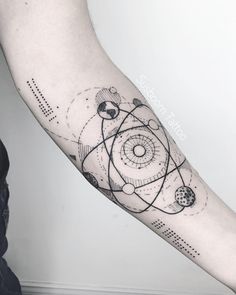 a person with a black and white tattoo on their arm that has an abstract design