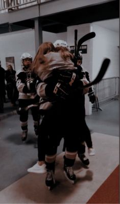 two women in hockey uniforms hugging each other