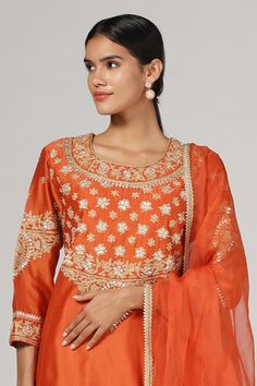 Orange silk chanderi kurta with zari and aari embroidery. Comes with salwar and an organza dupatta. - Aza Fashions Straight Kurta With Gota Work In Dola Silk, Transitional Semi-stitched Kurta With Gota Work, Dola Silk Traditional Wear With Resham Embroidery For Diwali, Traditional Dola Silk Wear With Resham Embroidery For Diwali, Festival Sets In Chanderi With Resham Embroidery, Straight Kurta With Gota Work In Chinon, Festival Sets In Slub Silk With Resham Embroidery, Chinon Straight Kurta With Gota Work, Festival Sets With Resham Embroidery In Slub Silk