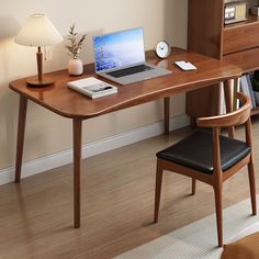 a laptop computer sitting on top of a wooden desk next to a lamp and chair