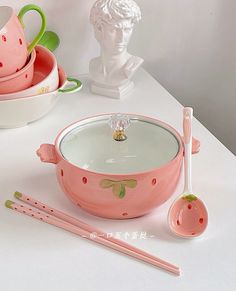 a white table topped with bowls and utensils next to a busturine