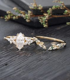 two gold rings with white and green stones on them, one has a diamond in the middle