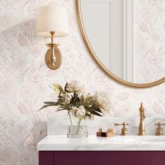 a bathroom vanity with a mirror and flowers on it