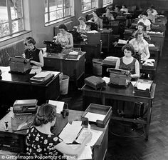 black and white photograph of women working at desks