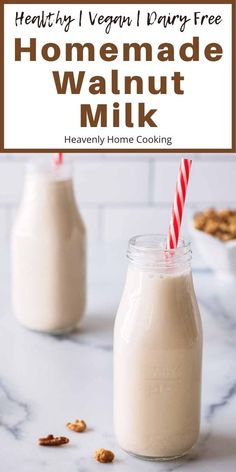 two jars filled with homemade walnut milk on top of a white countertop next to a red and white striped straw