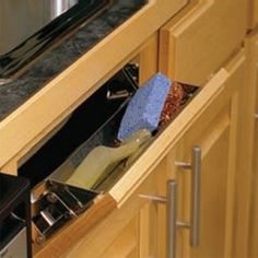 an open drawer in the middle of a kitchen counter