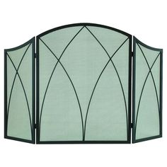 an iron fireplace screen with green glass panels